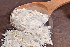 White flour in a wooden spoon