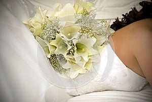 White flower bouquet on back of bride's back