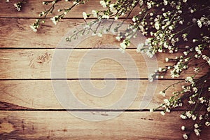 White flower on grunge wood board background with space.