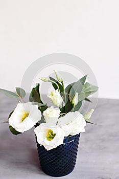 White flowers in classic blue glass. Lisianthus. Eustoma