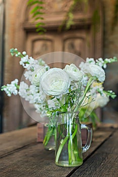 White flowers in a vintage style glass vase