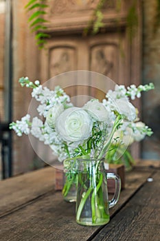 White flowers in a vintage style glass vase