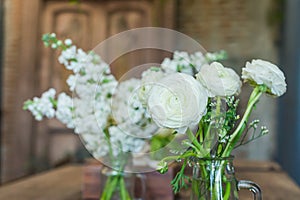 White flowers in a vintage style glass vase