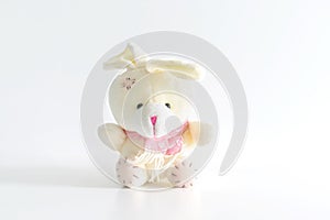 White fluffy bunny rabbit toy sitting on white background with copy space