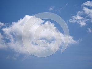 White fluffy cloud over blue summer sky background