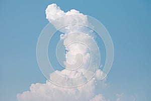 White fluffy clouds against blue sky in bright day for background texture