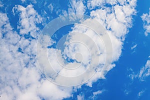 White fluffy clouds on a blue clear sky background