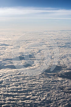 White, fluffy clouds in blue sky. Stratosphere.