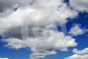 White fluffy clouds in a dark blue sky