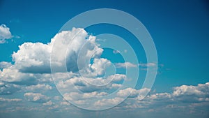 White Fluffy Clouds Slowly Float Through the Blue Daytime Sky Timelapse