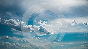 White Fluffy Clouds Slowly Float Through the Blue Daytime Sky Timelapse