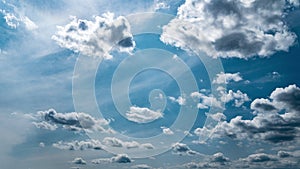 White Fluffy Clouds Slowly Float Through the Blue Daytime Sky Timelapse