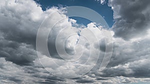 White Fluffy Clouds Slowly Float Through the Blue Daytime Sky Timelapse