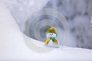 On the white fluffy textured snow alone snowman.