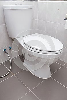 White flush toilet in modern bathroom