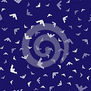 White Flying bat icon isolated seamless pattern on blue background. Vector
