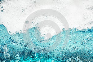 White foam blue water background closeup, sea or ocean foam wave pattern, froth bubbles texture, soap spume backdrop, soap sud