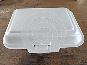 a white foam box on a wooden table