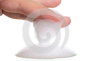 White foam bubbles texture with child finger and hand isolated