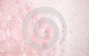 White foam bubbles texture on pink pastel background, copy space, banner for loundry, cleaning service, bathroom concept, clean,