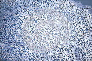 White foam bubles on blue color water
