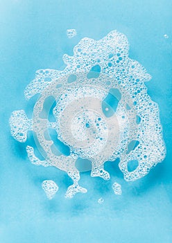 White foam detergent on a blue background.