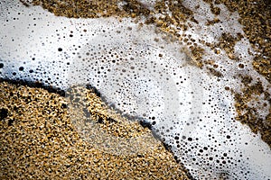 White foam of the sea on the beach