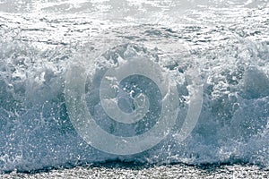 White foam sliding over sand. powerful ocean waves breaking natural background, Phuket