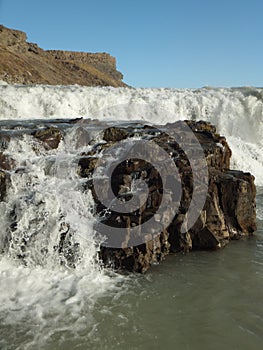 Detail of Gullfoss waterfall in Iceland, water cascading on the rock