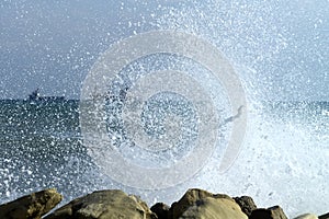 Sea wave splash on rocks