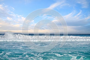 White foamy waves and gradually darkening color of sea