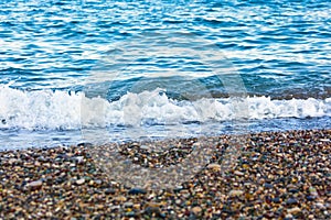 The white foamy waves on the pebble stones of the Mediterranean in Konyaalti Beach.