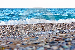 The white foamy waves on the pebble stones of the Mediterranean in Konyaalti Beach.