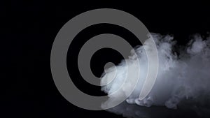 White fog swirls on isolated black studio background, slow motion