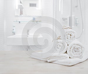 White folded spa towels on defocused interior background of bathroom