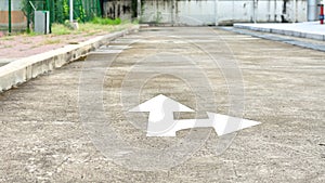White forward and right directional arrow on asphalt