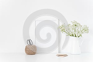 White frame mock up with Aegopodium a in vase.Mockup for design.Template for small businesses, lifestyle bloggers, media