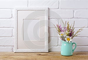 White frame mockup with chamomile and purple field flowers in mi