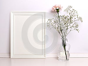 White frame mockup with flowers.