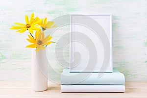 White frame mockup with golden yellow rosinweed and books photo