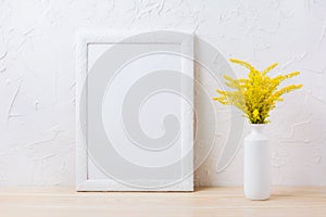 White frame mockup with ornamental yellow flowering grass in vase