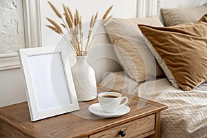 White frame mockup on retro bedside table in bedroom