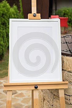 White frame mockup on a wooden stand