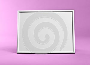 White frame for paintings or photographs on pink background.