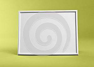 White frame for paintings or photographs on yellow background.