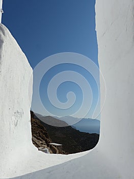 White frame with a panorama of coast and mountain to Amorgos in Greece.