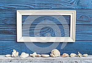 White frame and shells on a background of blue boards