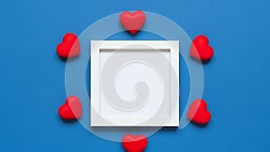 White frame surrounded by red hearts on blue background