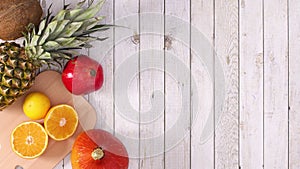 White frame for text or logo appear with tropic fruits on wooden theme. Stop motion