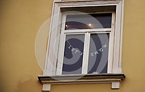 White frame window in old town building with christmas writing decoration